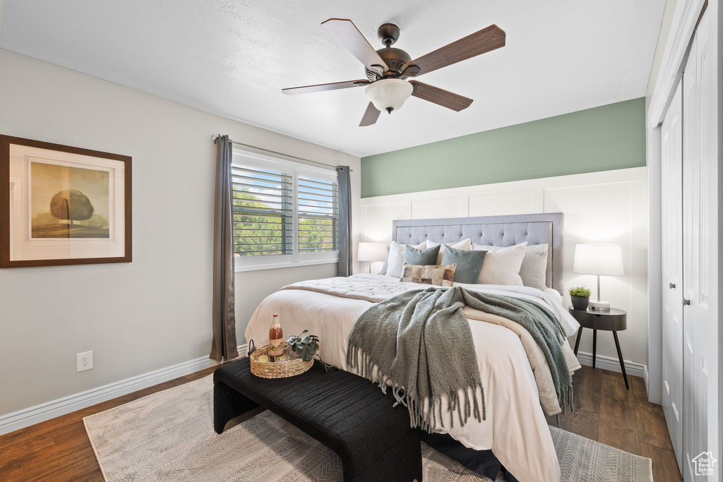 Bedroom featuring a closet, wood finished floors, and ceiling fan
