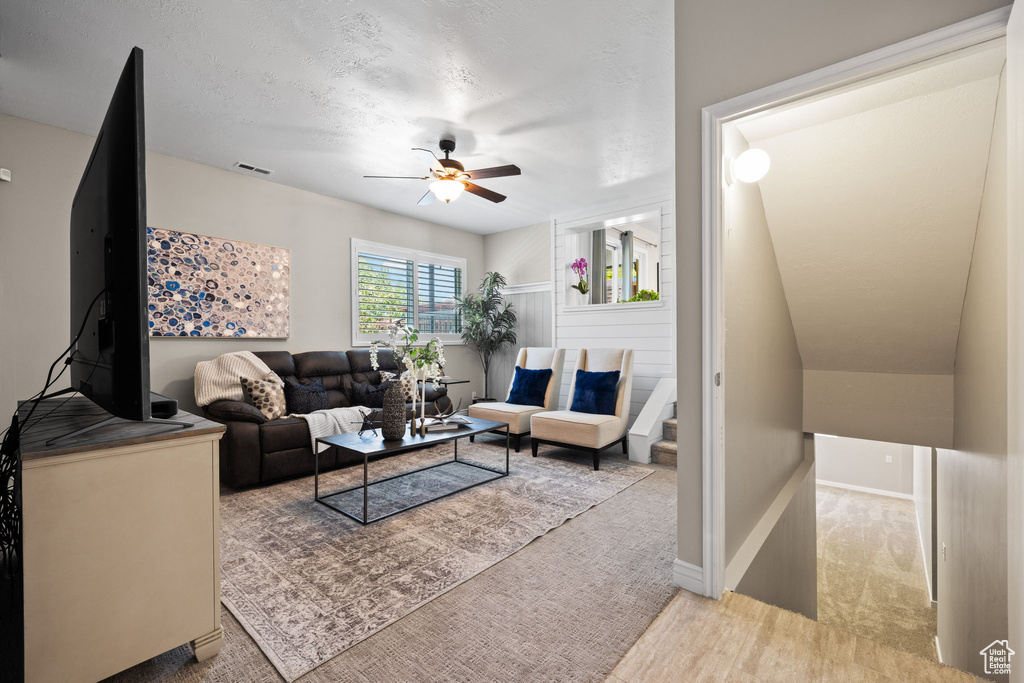 Living area featuring a ceiling fan and wood finished floors