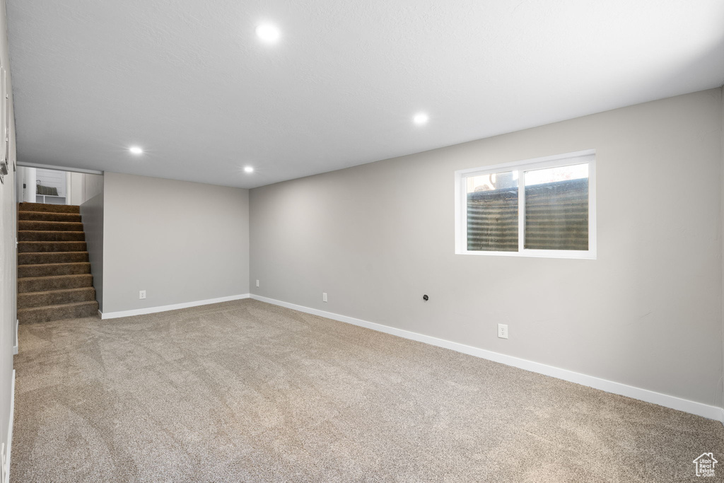 Basement with carpet, recessed lighting, and stairway