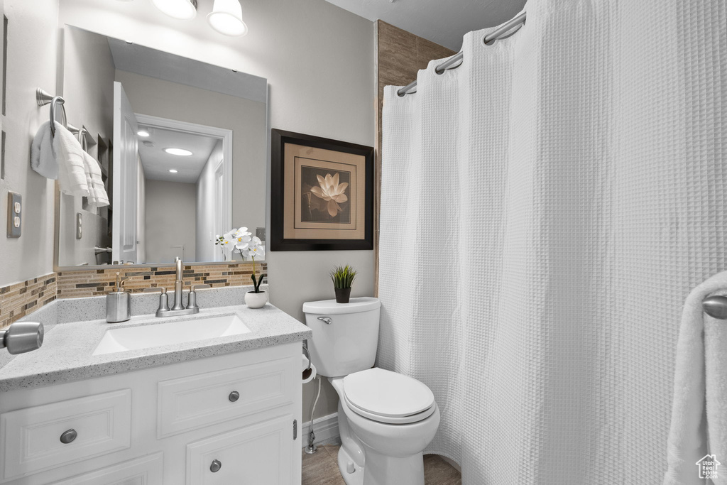 Bathroom with decorative backsplash and vanity