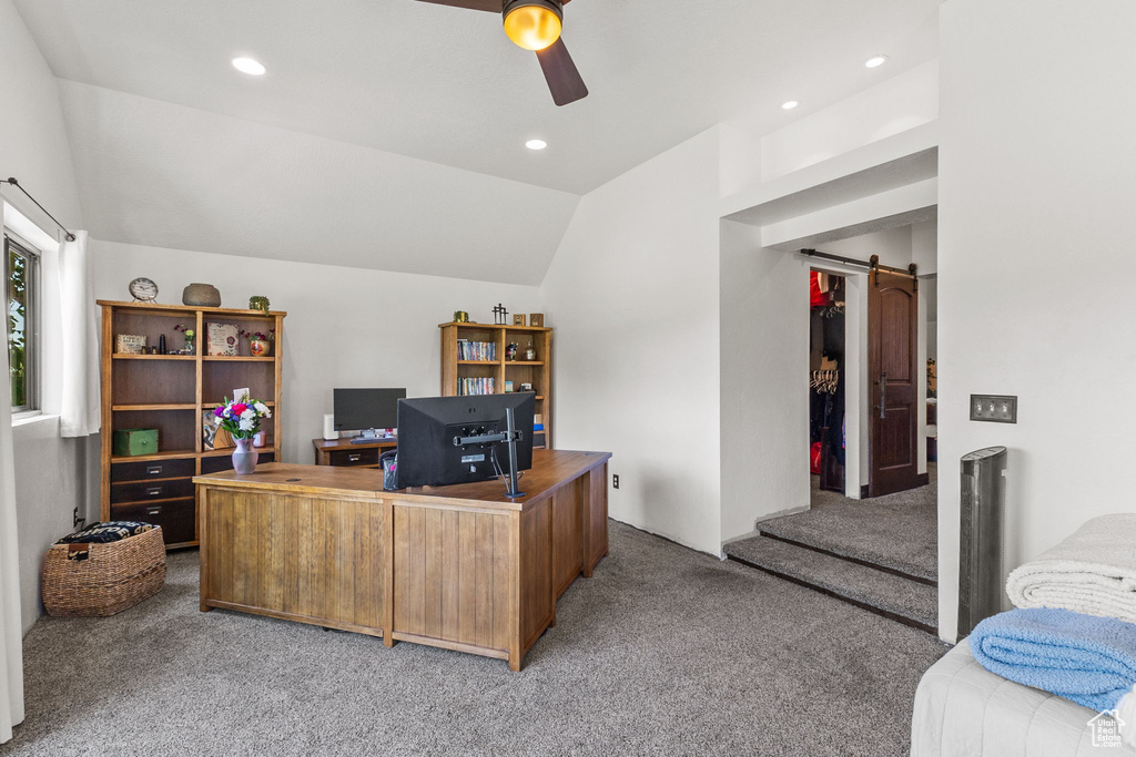 Office with light colored carpet, a ceiling fan, a barn door, vaulted ceiling, and recessed lighting