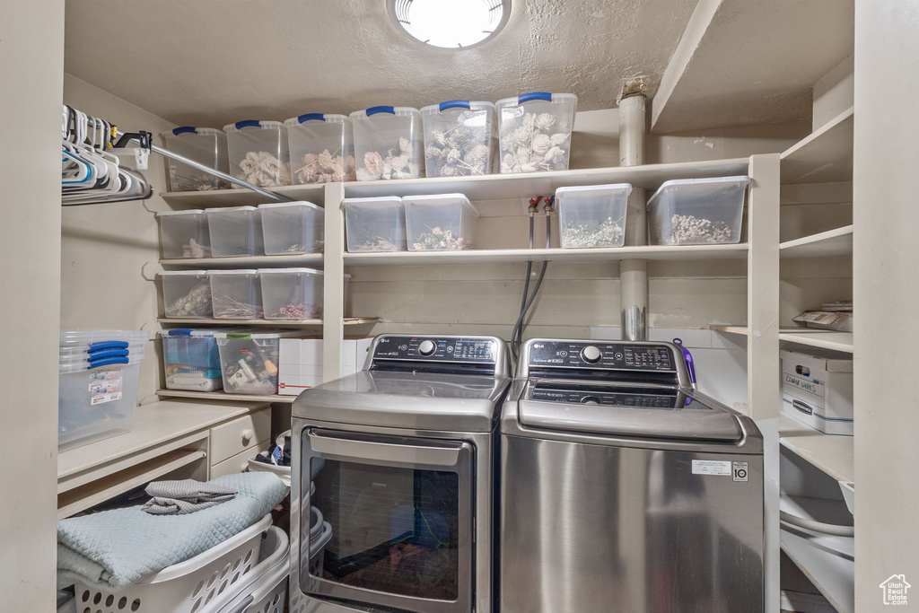 Laundry room featuring washing machine and clothes dryer