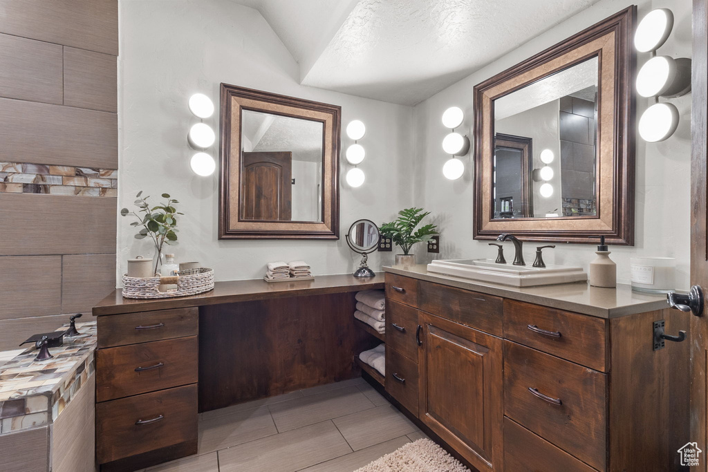 Bathroom with vanity and tile patterned flooring