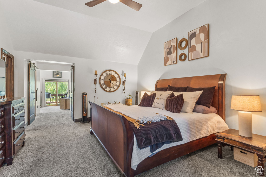 Carpeted bedroom with lofted ceiling and a ceiling fan