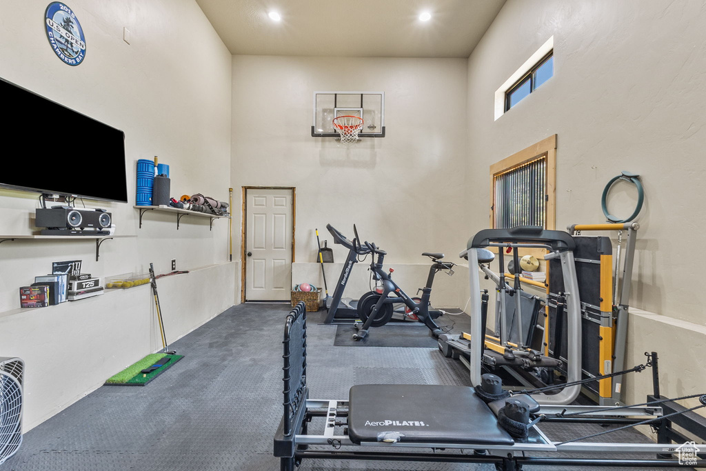 Exercise room featuring a towering ceiling
