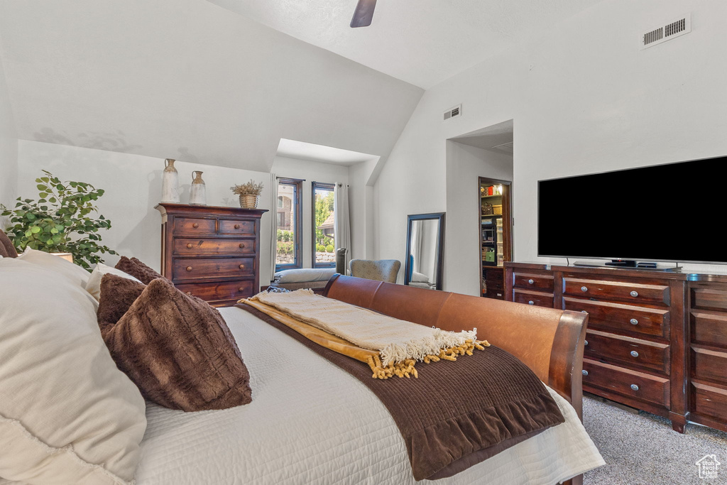 Bedroom featuring carpet flooring, a ceiling fan, and high vaulted ceiling