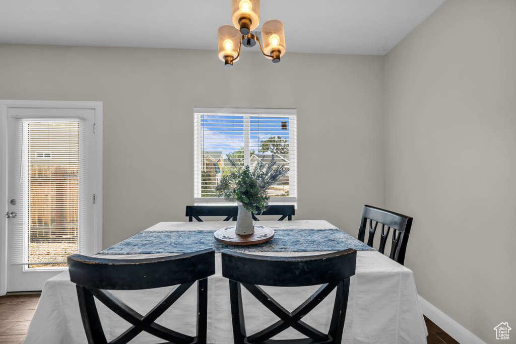 Dining area featuring a chandelier and baseboards