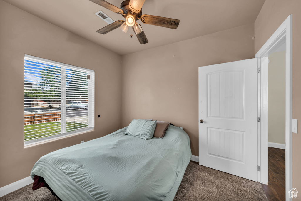 Bedroom with a ceiling fan and carpet floors
