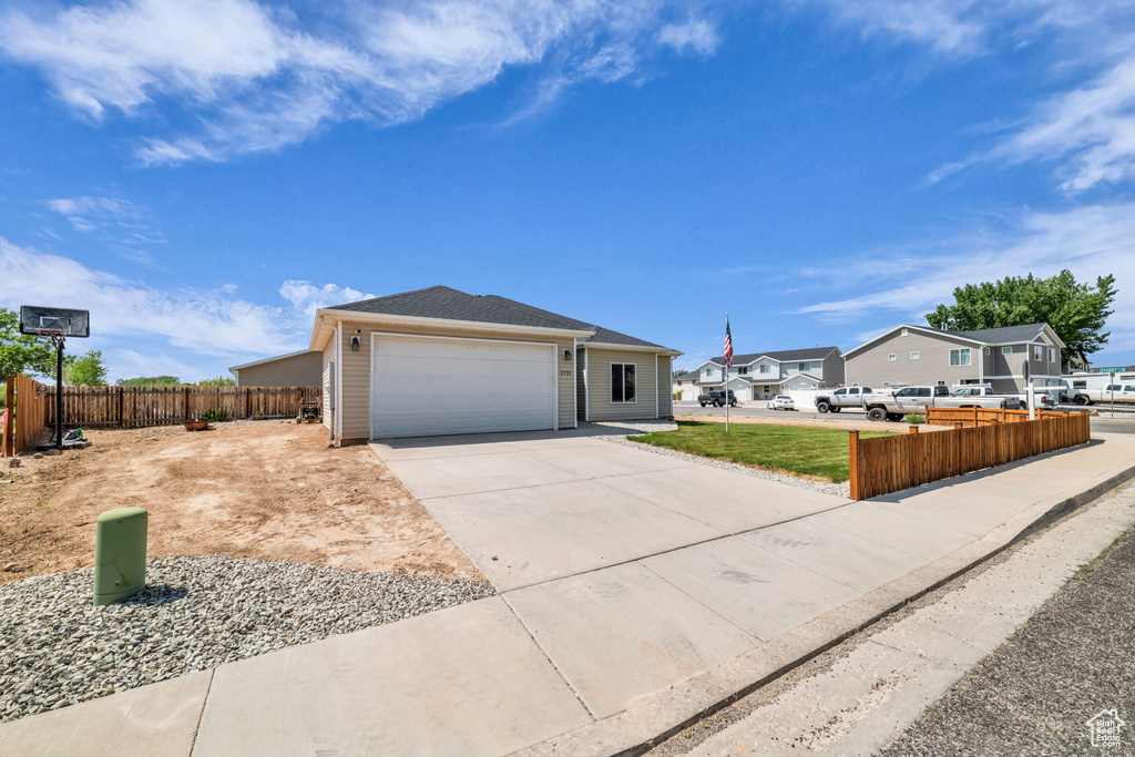 Ranch-style home with driveway and an attached garage