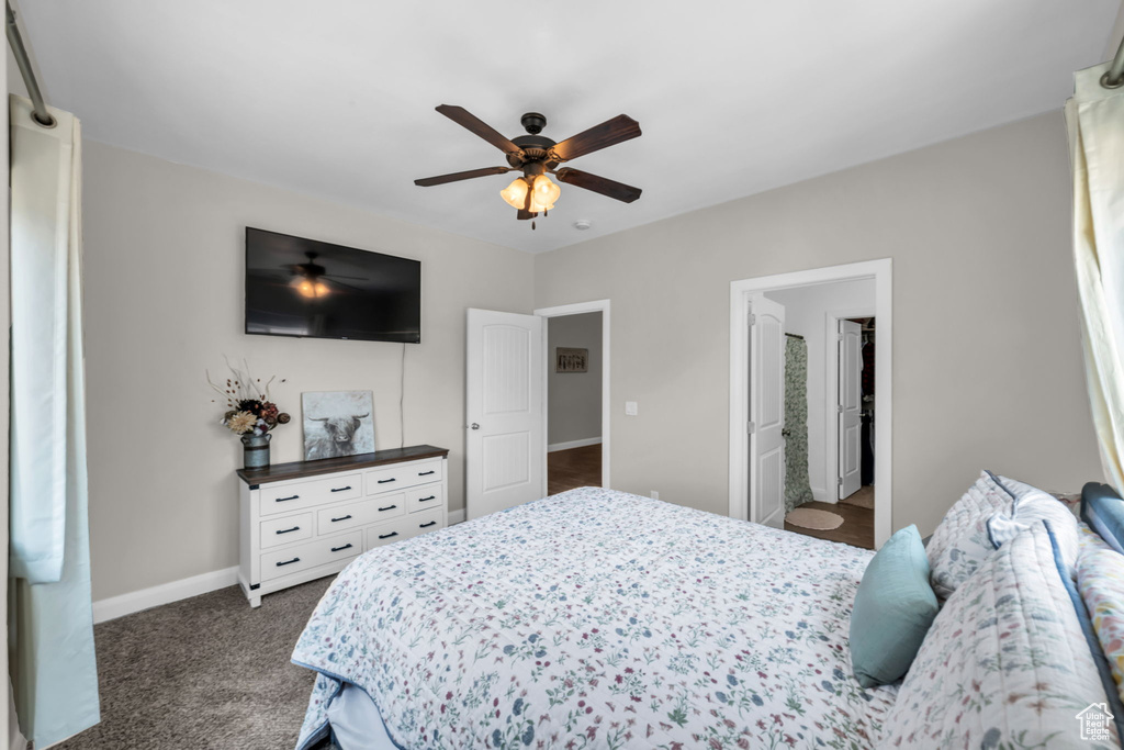 Bedroom with dark colored carpet and ceiling fan