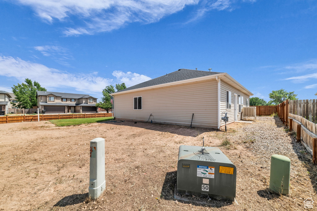 View of side of home with a fenced backyard