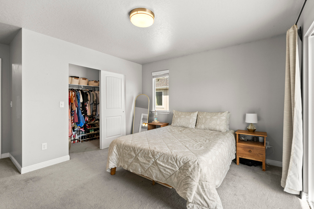 Bedroom with carpet and a closet