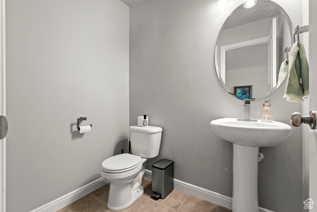 Bathroom featuring toilet and baseboards