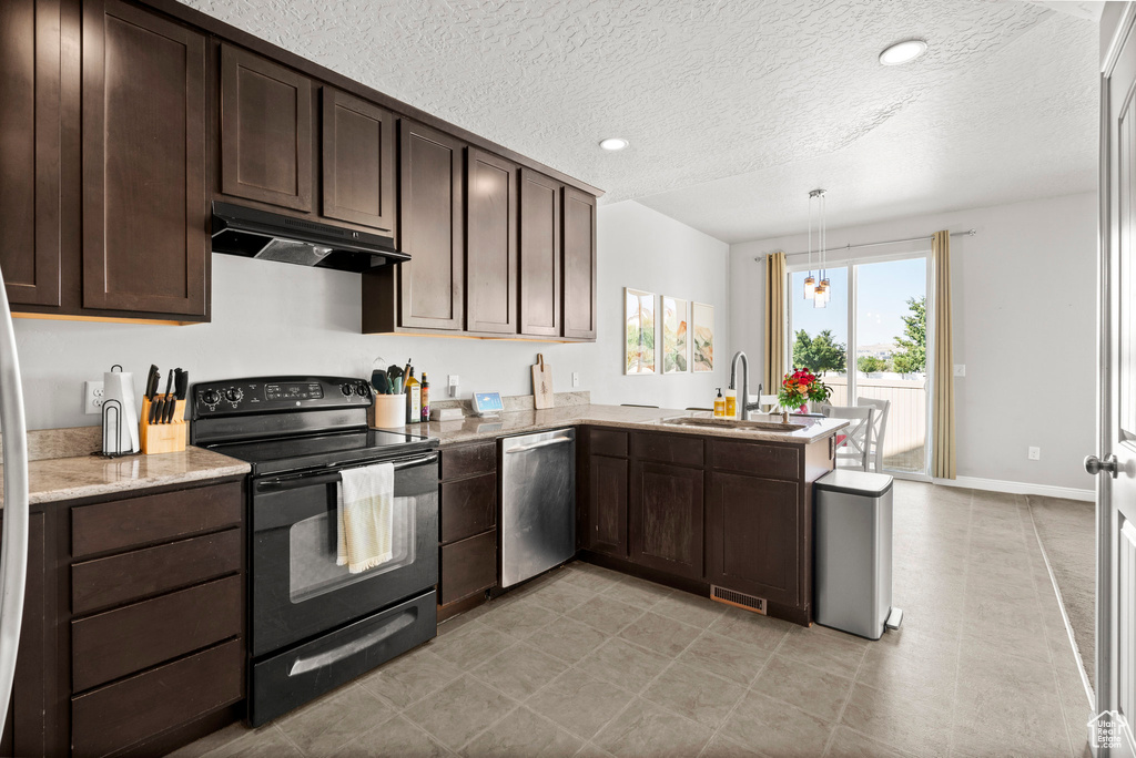 Kitchen featuring black electric range, under cabinet range hood, dishwasher, dark brown cabinetry, and a textured ceiling