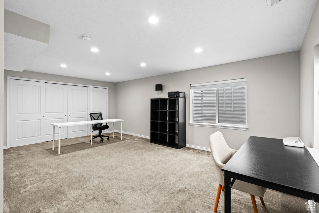 Carpeted home office featuring recessed lighting and baseboards