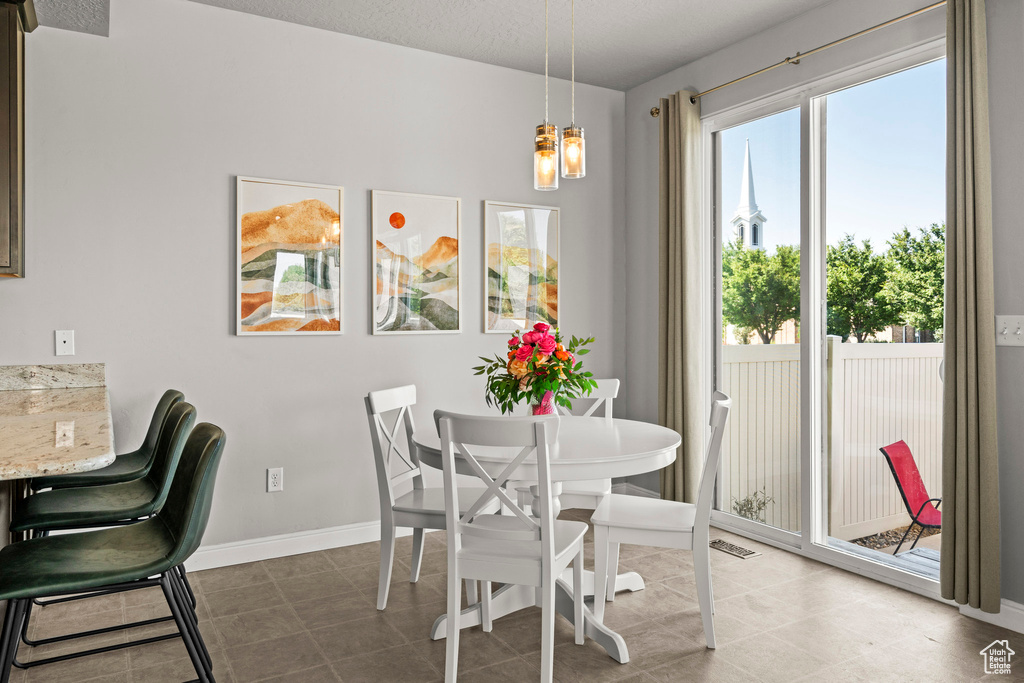 Dining room with a chandelier and baseboards