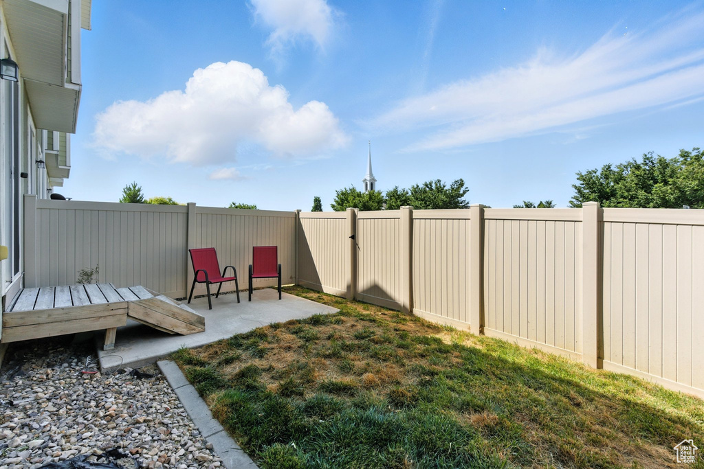 Fenced backyard featuring a patio