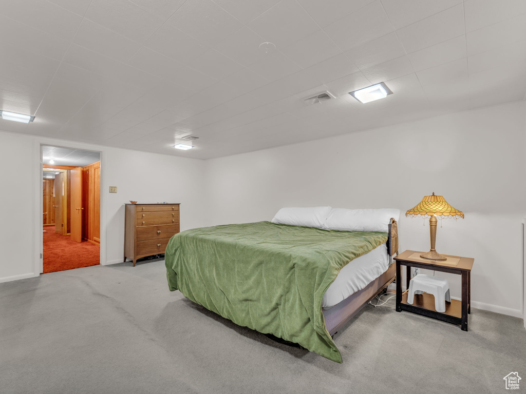 Bedroom featuring carpet flooring and baseboards