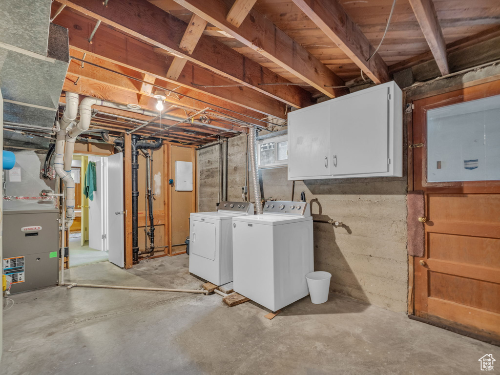 Below grade area with washing machine and clothes dryer