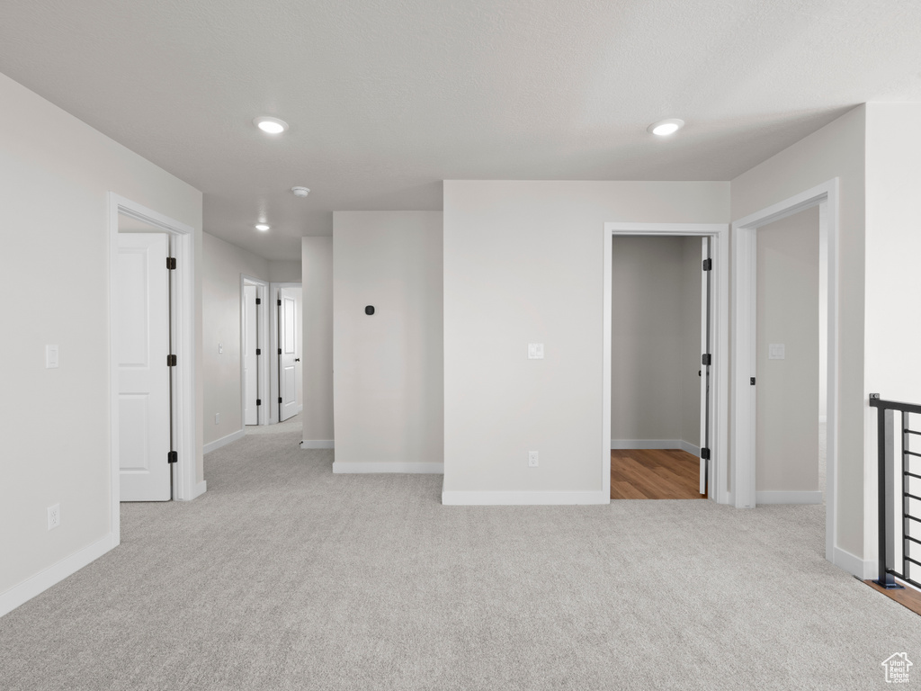 Empty room featuring light colored carpet and recessed lighting