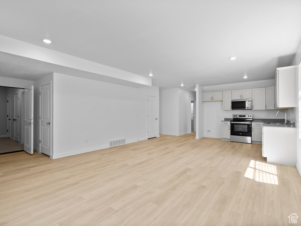 Unfurnished living room with recessed lighting and light wood finished floors