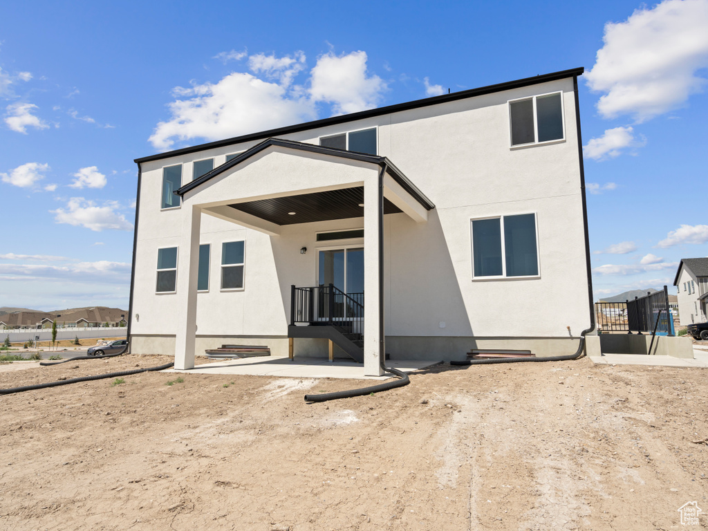 Rear view of property featuring stucco siding
