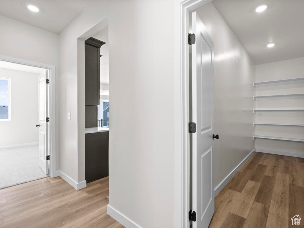 Hallway featuring light wood finished floors and recessed lighting