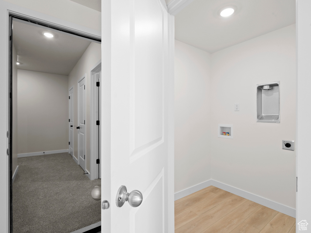 Laundry area with hookup for a washing machine, hookup for an electric dryer, recessed lighting, and light wood-style floors