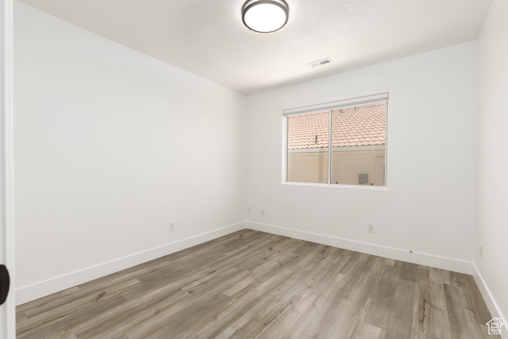 Unfurnished room featuring light wood-style flooring and baseboards