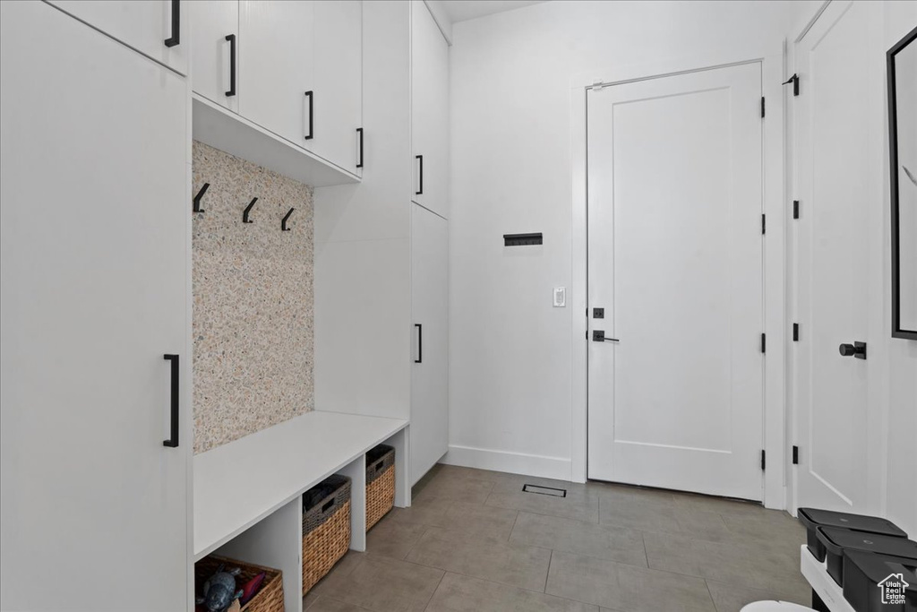 Mudroom with light tile patterned flooring and baseboards