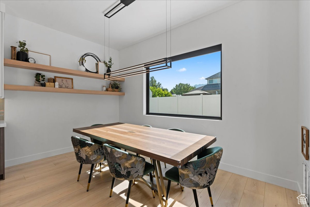 Dining room featuring light wood-style floors and baseboards