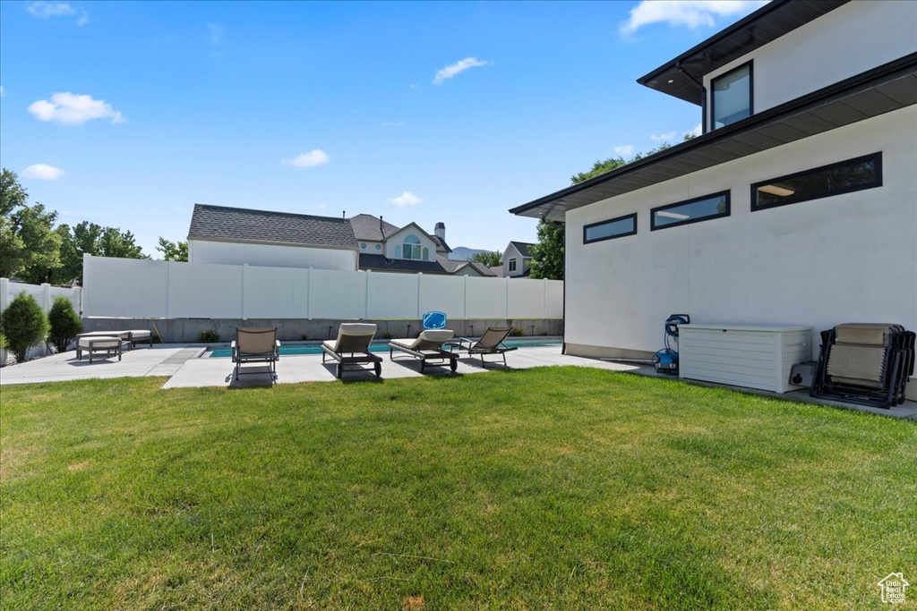 Fenced backyard with a patio area