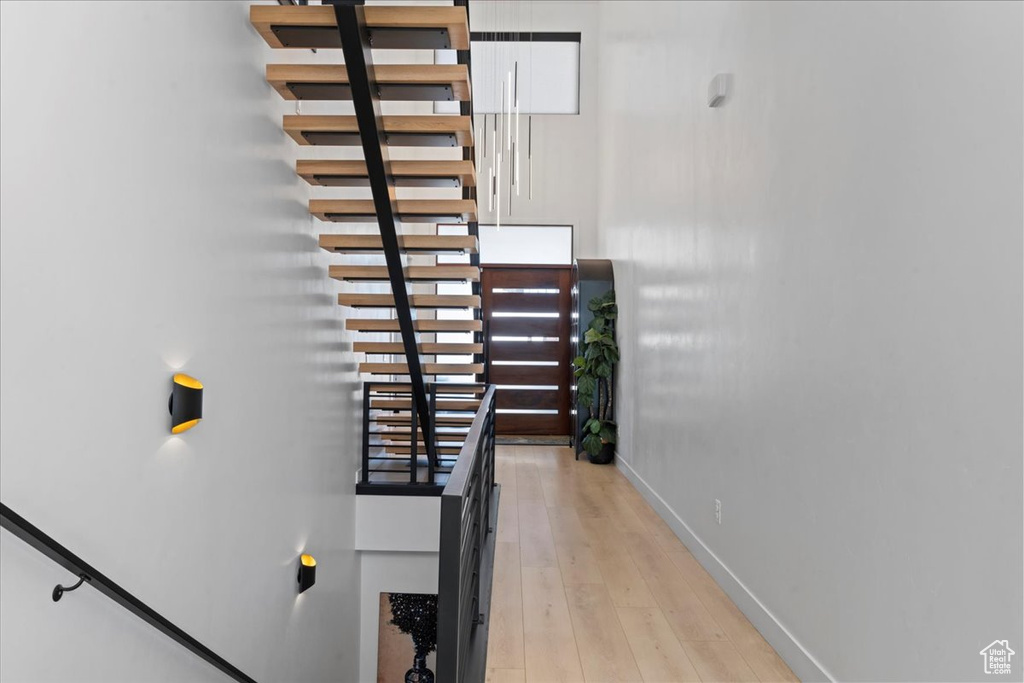 Stairway featuring baseboards and wood finished floors