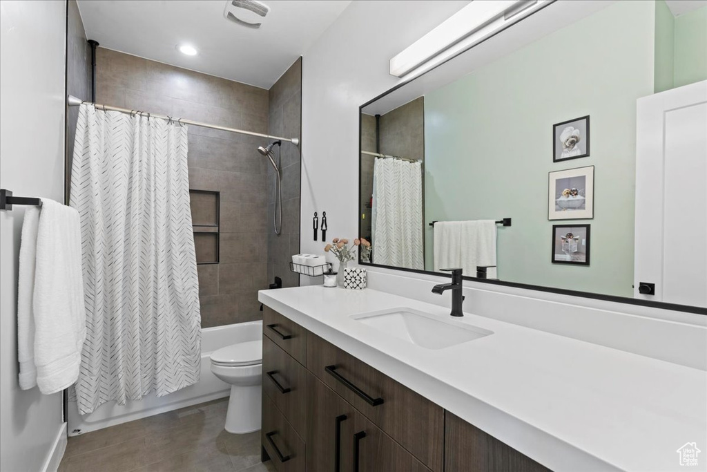 Bathroom featuring vanity and shower / tub combo with curtain