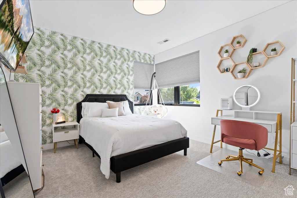 Carpeted bedroom featuring wallpapered walls