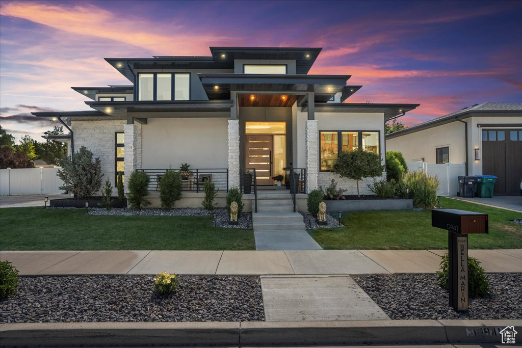View of front of home featuring stucco siding and a porch
