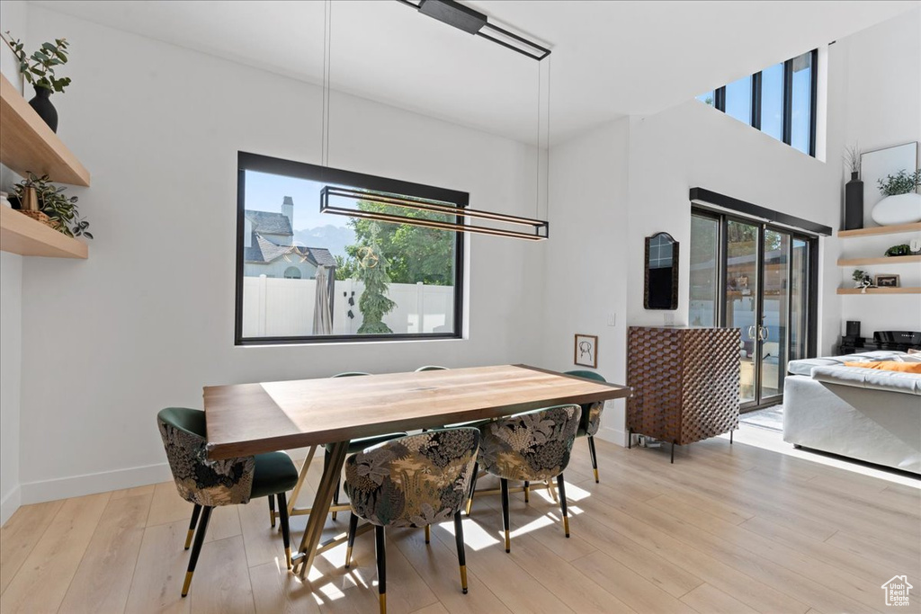 Dining space with baseboards and light wood finished floors