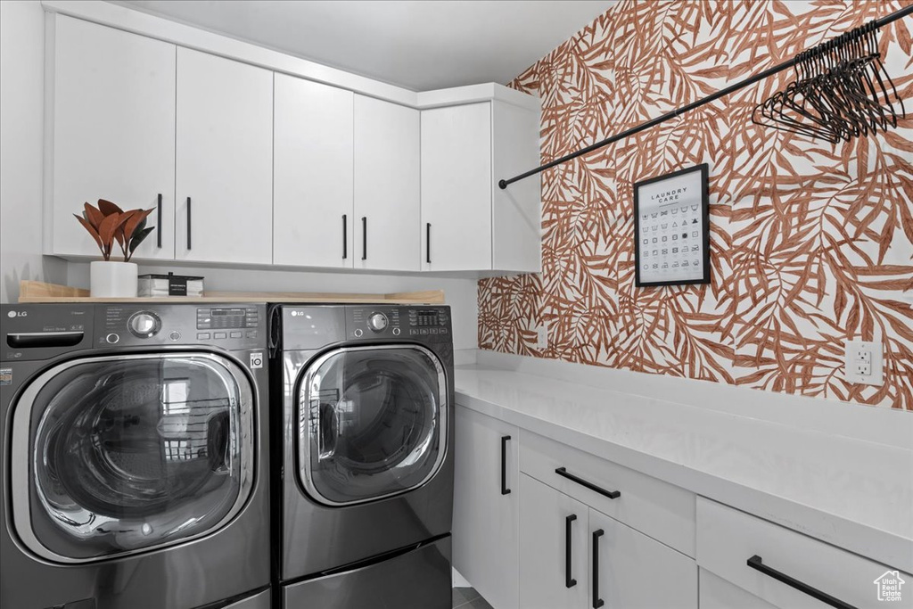 Laundry room with cabinet space and independent washer and dryer
