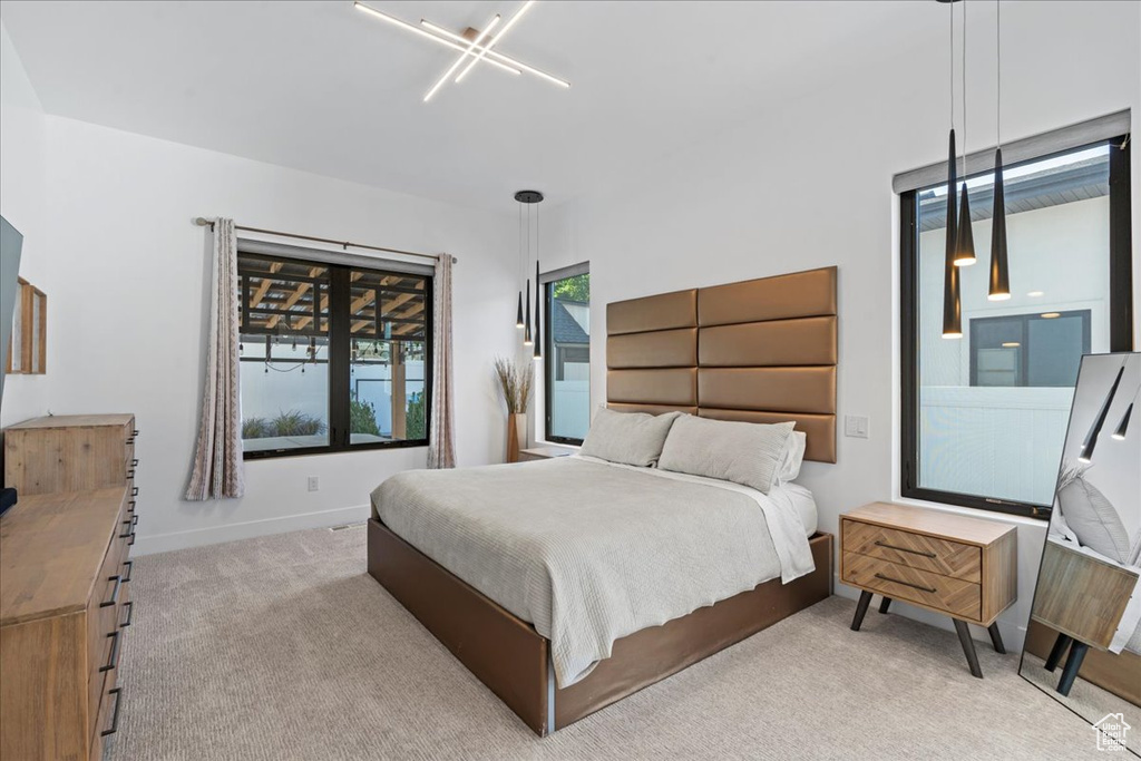Bedroom featuring light colored carpet and baseboards
