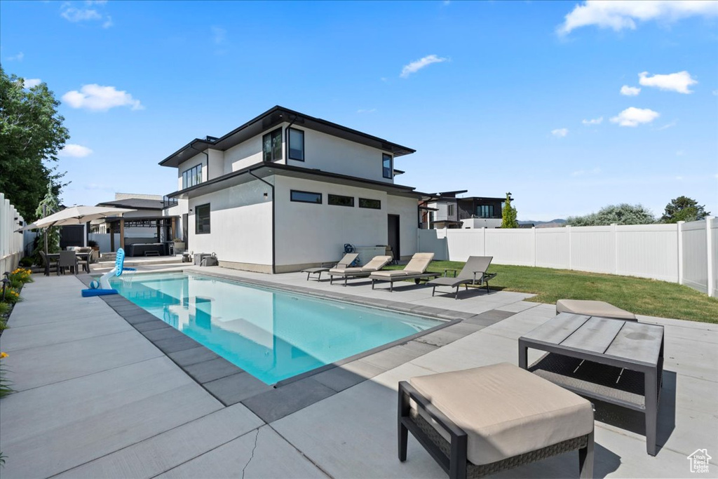 View of swimming pool featuring a patio and a fenced backyard