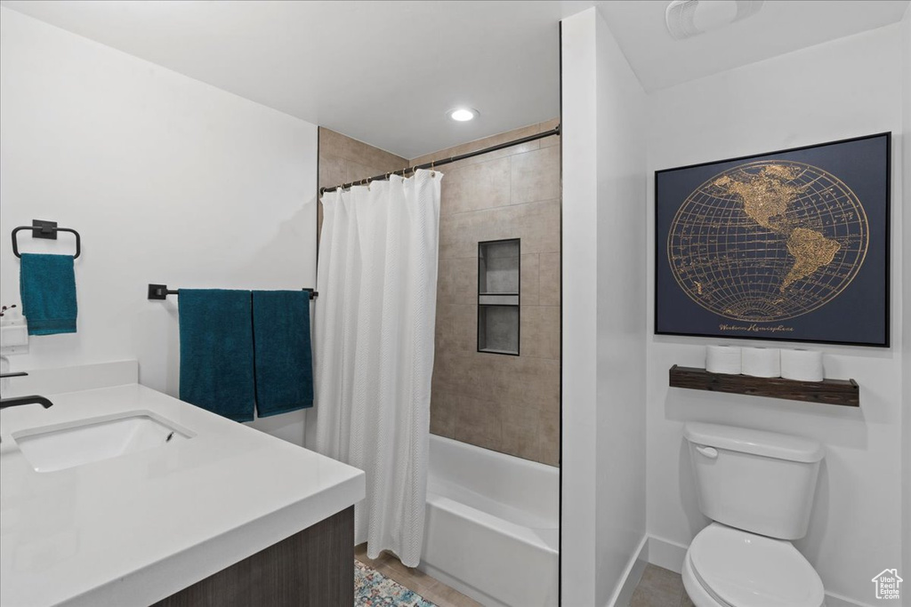 Bathroom with vanity, shower / tub combo, and recessed lighting