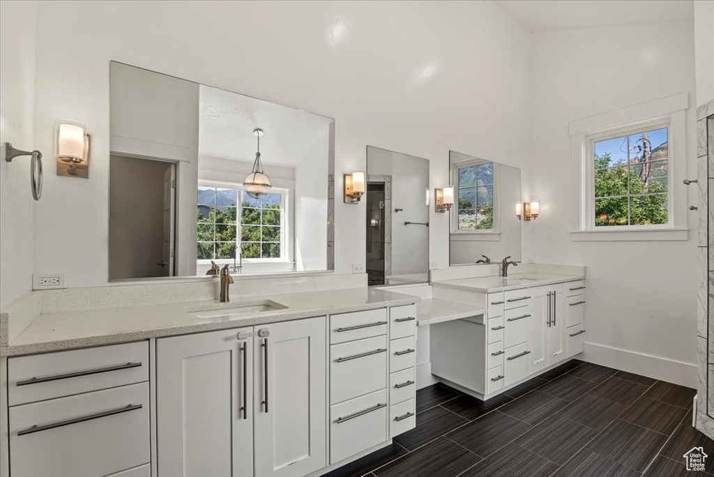 Full bath featuring two vanities and a shower