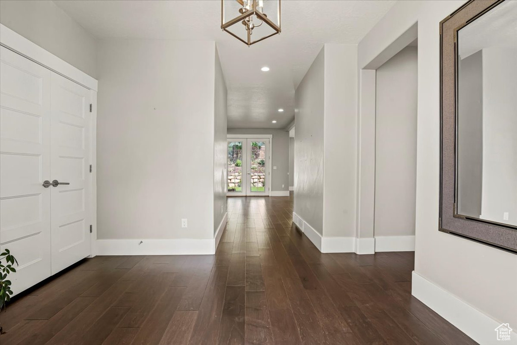 Entryway featuring dark wood finished floors, a chandelier, and recessed lighting