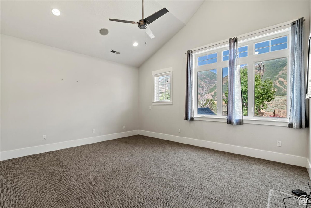 Carpeted spare room with a ceiling fan, recessed lighting, and high vaulted ceiling
