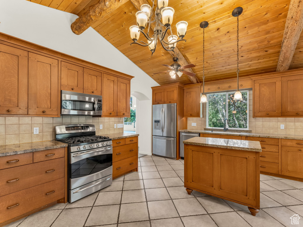 Kitchen with stainless steel appliances, wood ceiling, decorative backsplash, brown cabinetry, and a chandelier