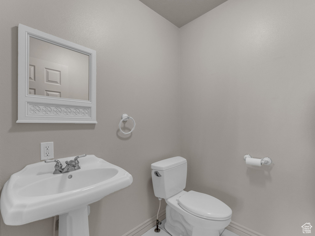 Bathroom with baseboards and tile patterned floors