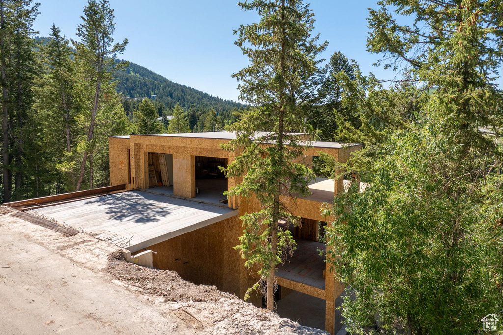 View of front facade with a forest view and a mountain view