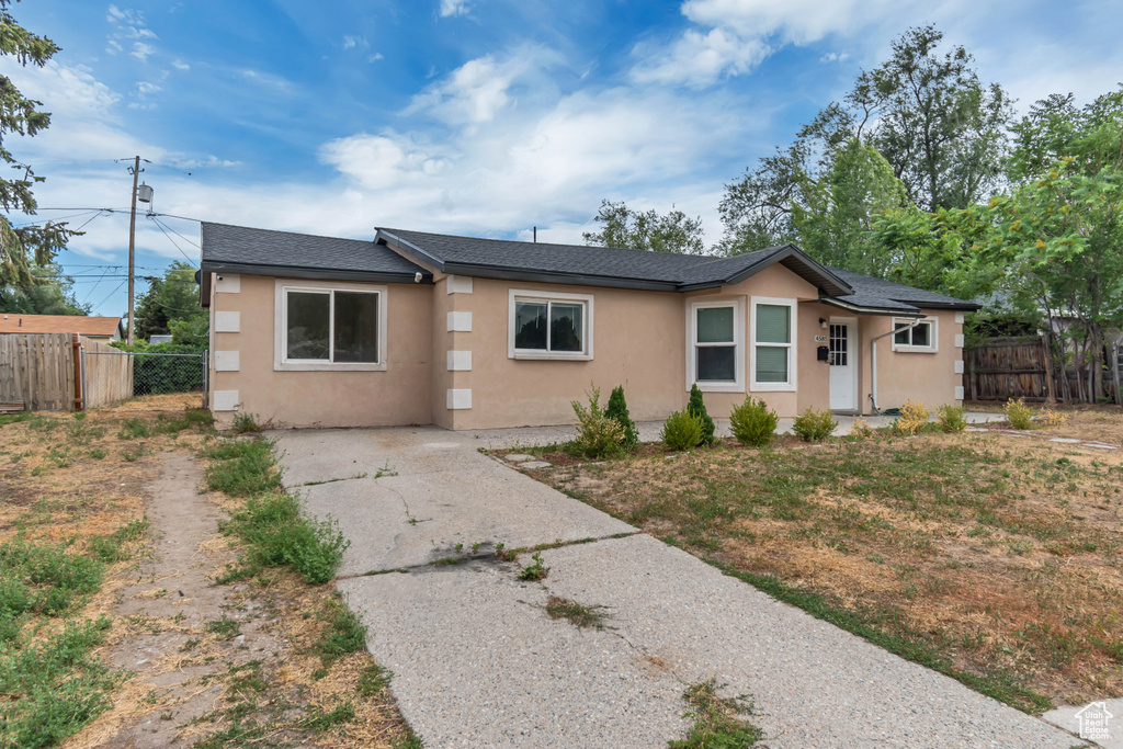 Single story home with stucco siding and roof with shingles