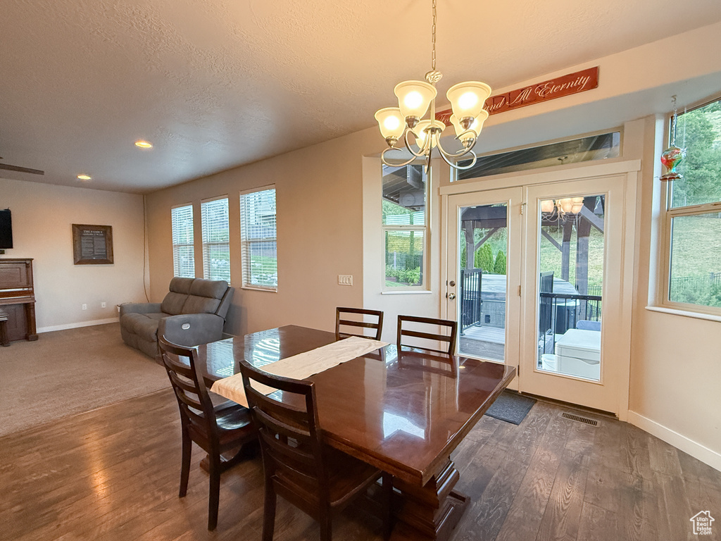 Dining space featuring a chandelier, wood finished floors, and recessed lighting