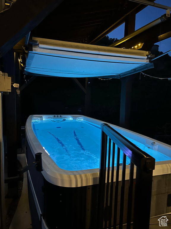 View of pool with a hot tub
